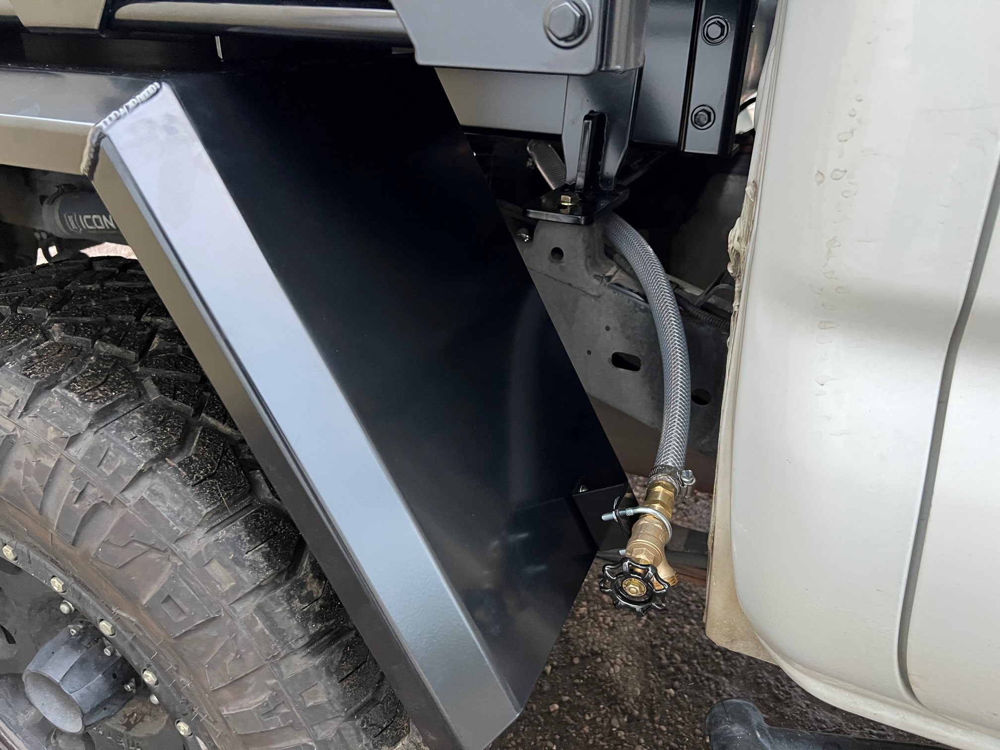 Summit Expedition Trucks water tank mounted under the truck flatbed